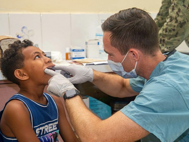Dentist gently examining a child’s teeth